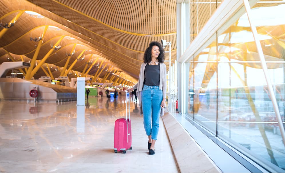 Woman walking through an airport terminal — the expat lifestyle